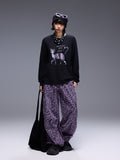 Model wearing Wild Urban Leopard Cargo Pants paired with a graphic black sweatshirt and accessories