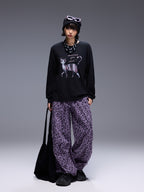 Model wearing Wild Urban Leopard Cargo Pants paired with a graphic black sweatshirt and accessories