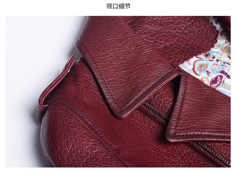 Close-up of women's wine leather moto jacket showcasing detailed collar and texture