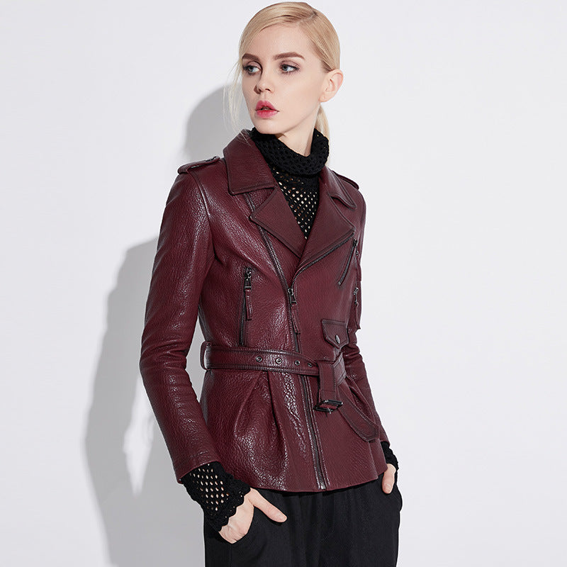 Stylish women's wine leather moto jacket with belted waist and zippered pockets