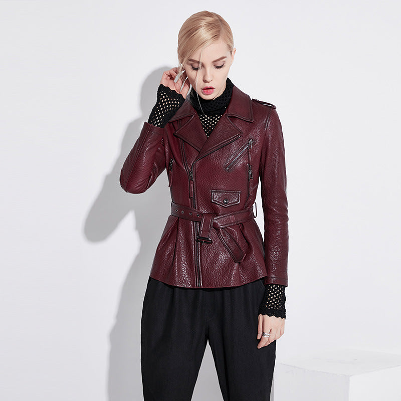 Women's wine leather moto jacket featuring a belted waist and stylish zippered pockets