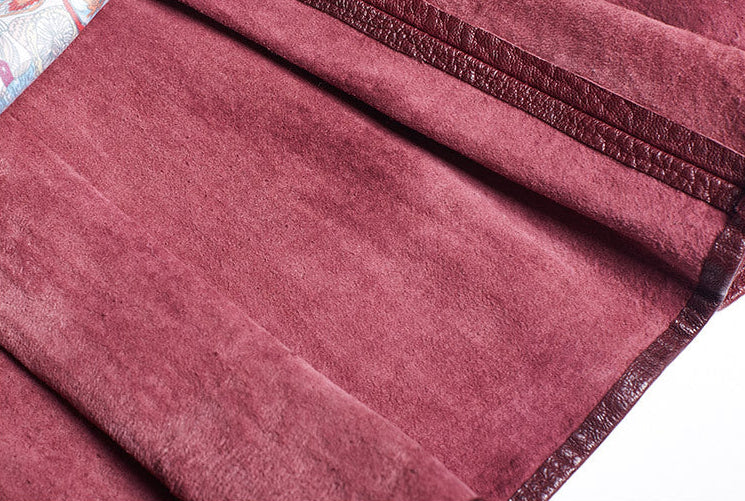 Close-up view of a women's wine leather moto jacket showcasing its soft texture and rich color